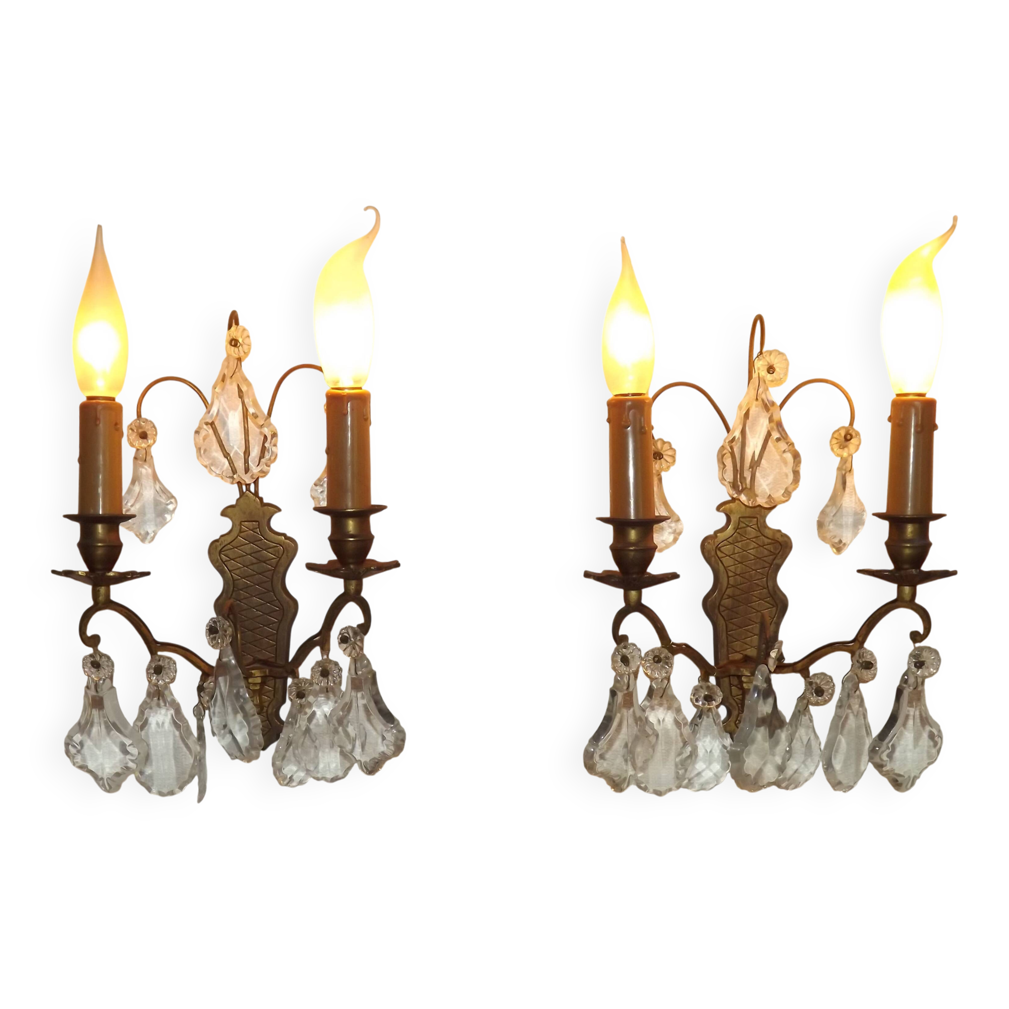 Pair of French antique brass double wall lights with assorted crystals.