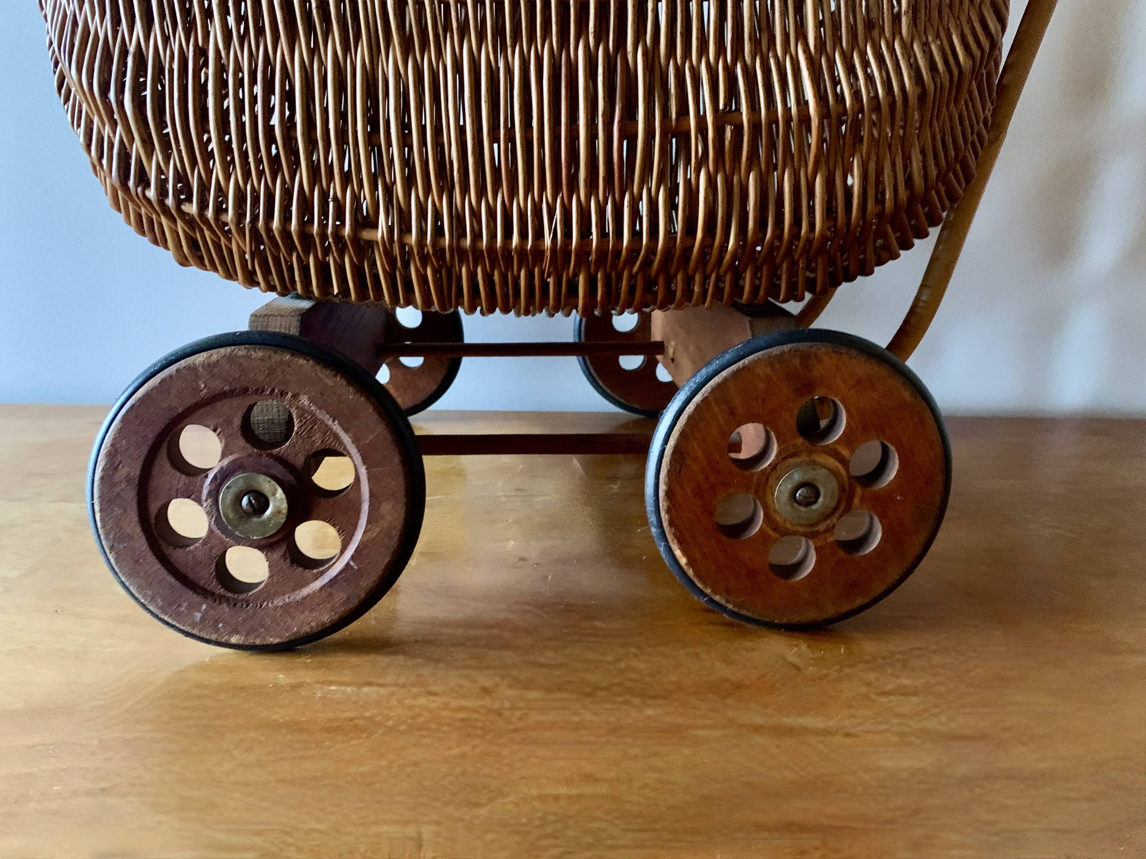 Old wicker dolls' pram - wooden wheels
