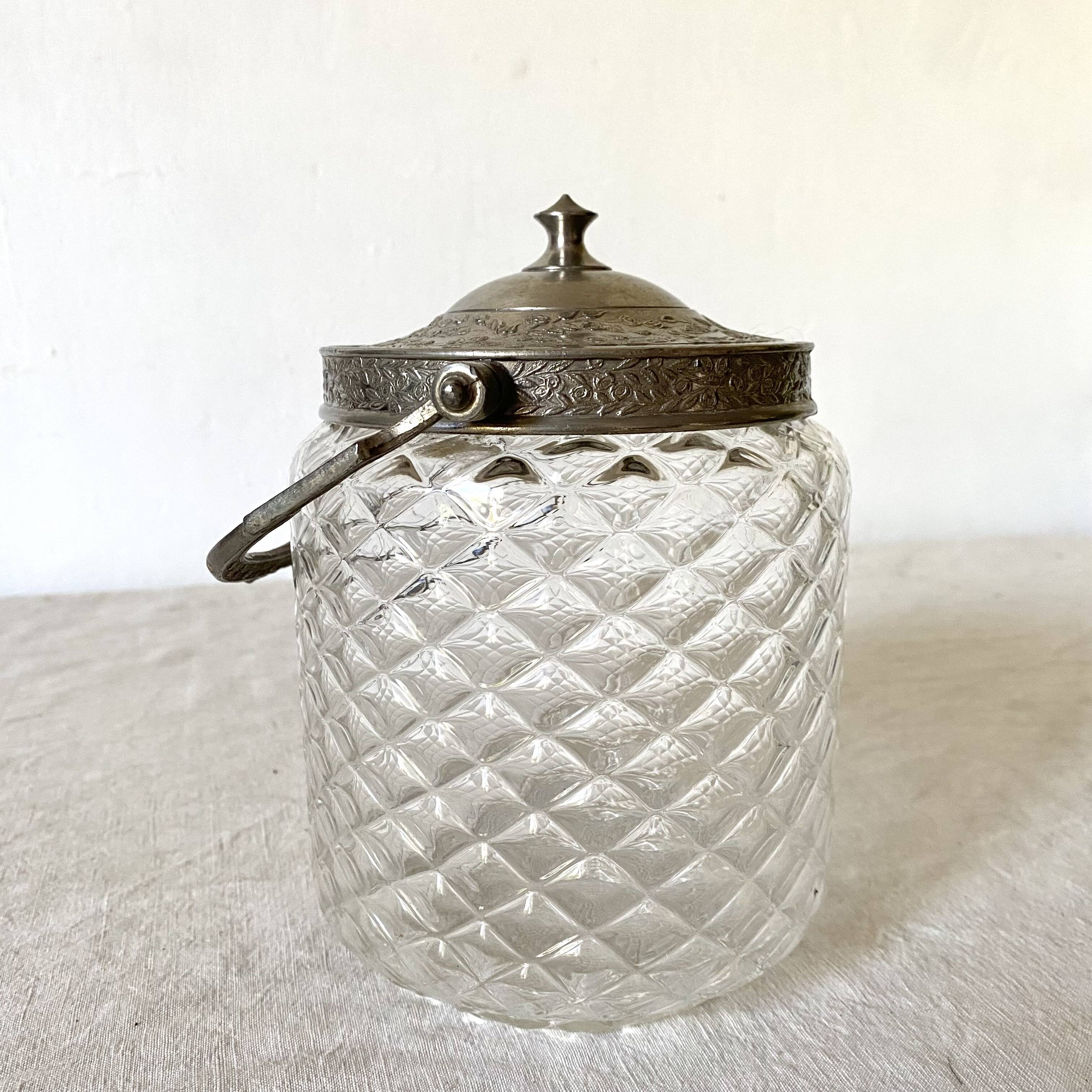 Old biscuit bucket in glass and metal