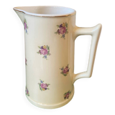 Old flowery and gilded pitcher.