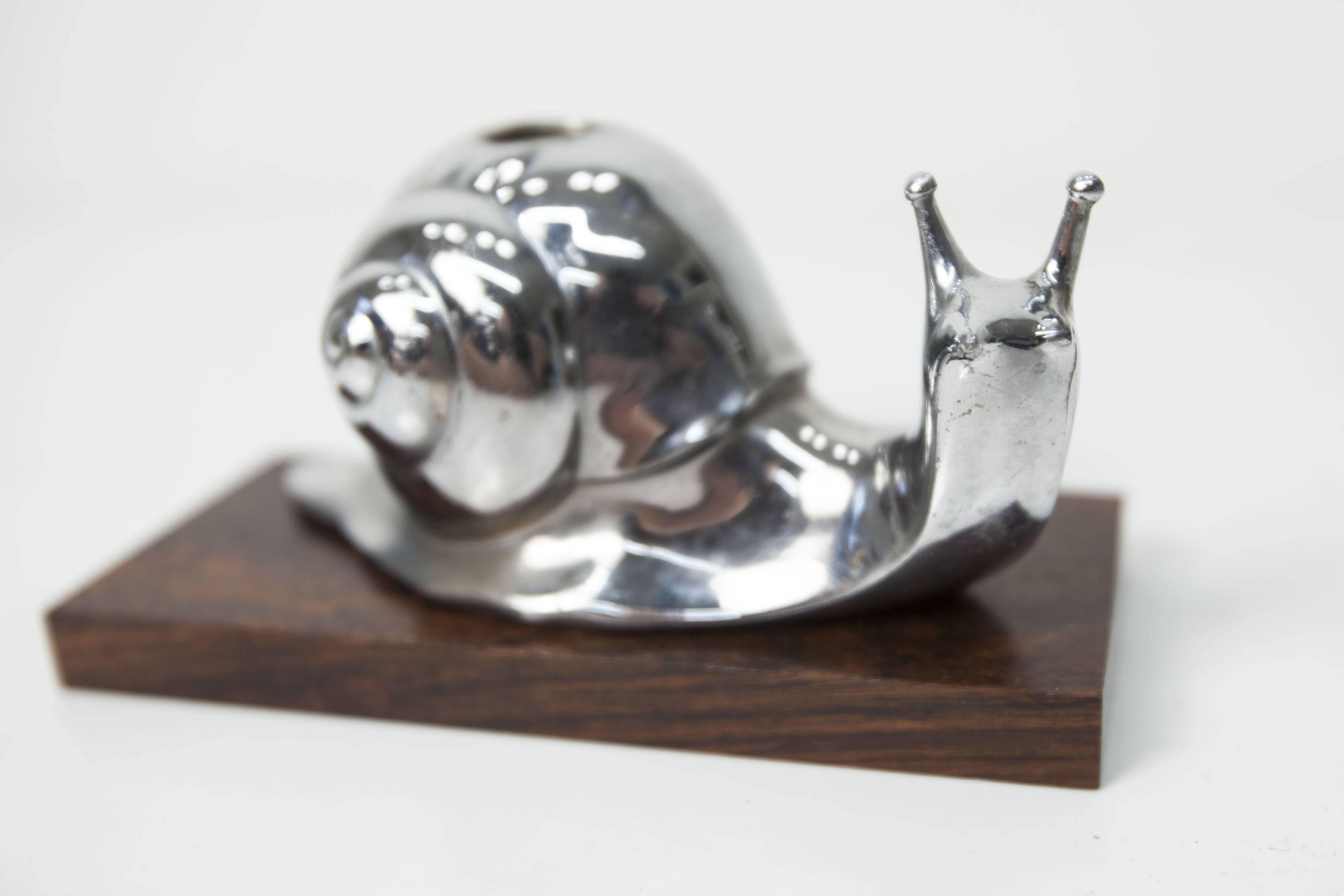 Silver snail candlestick on a teak base 1960