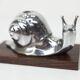 Silver snail candlestick on a teak base 1960