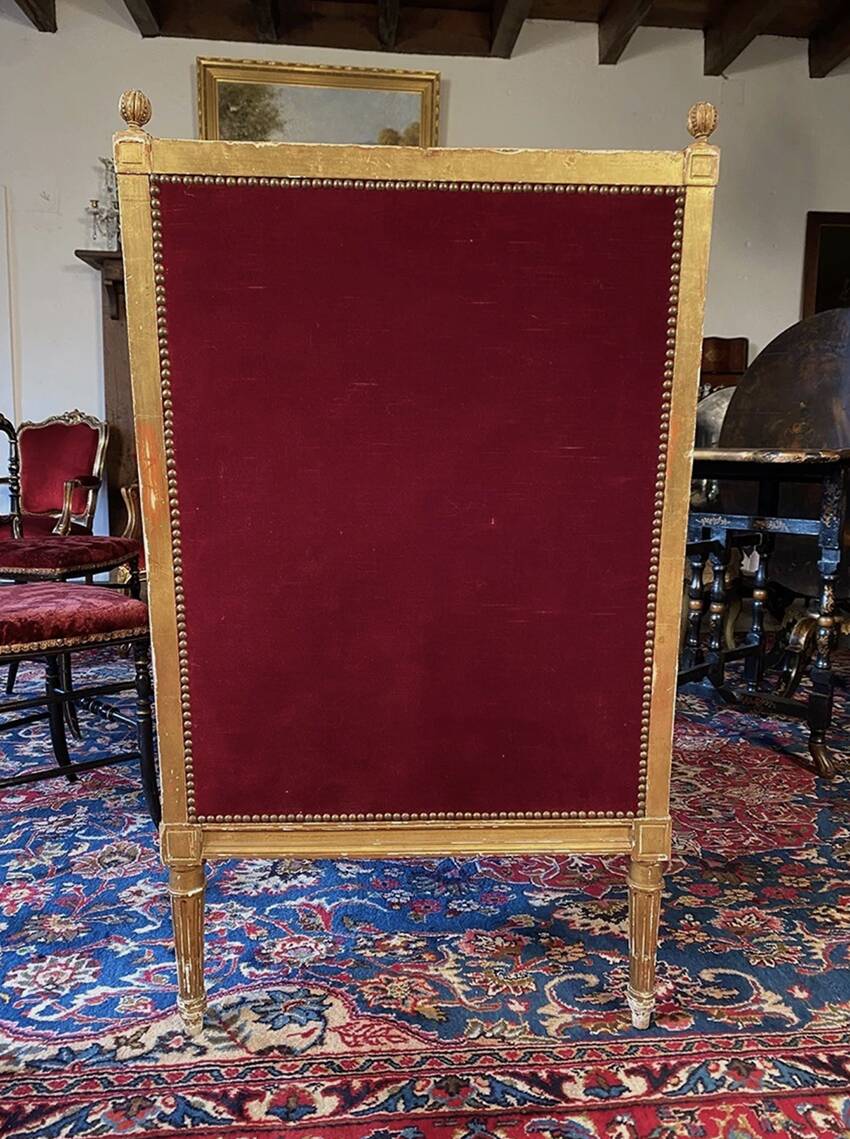 Golden wooden bergère in Louis XVI style upholstered in Bordeaux velvet.