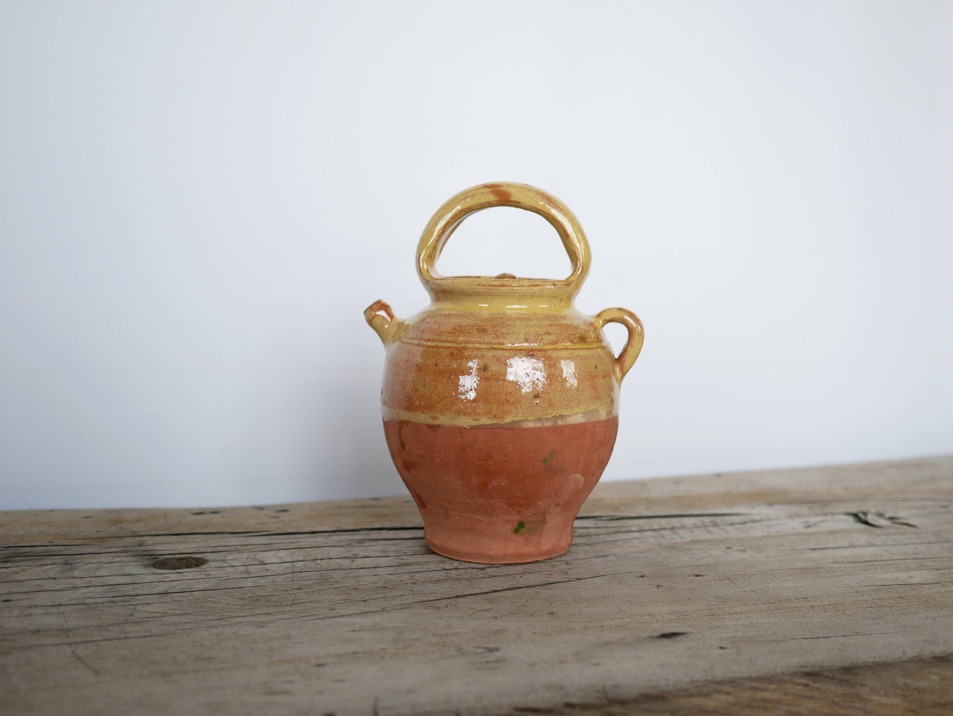 Old gargoulette pot in glazed terracotta