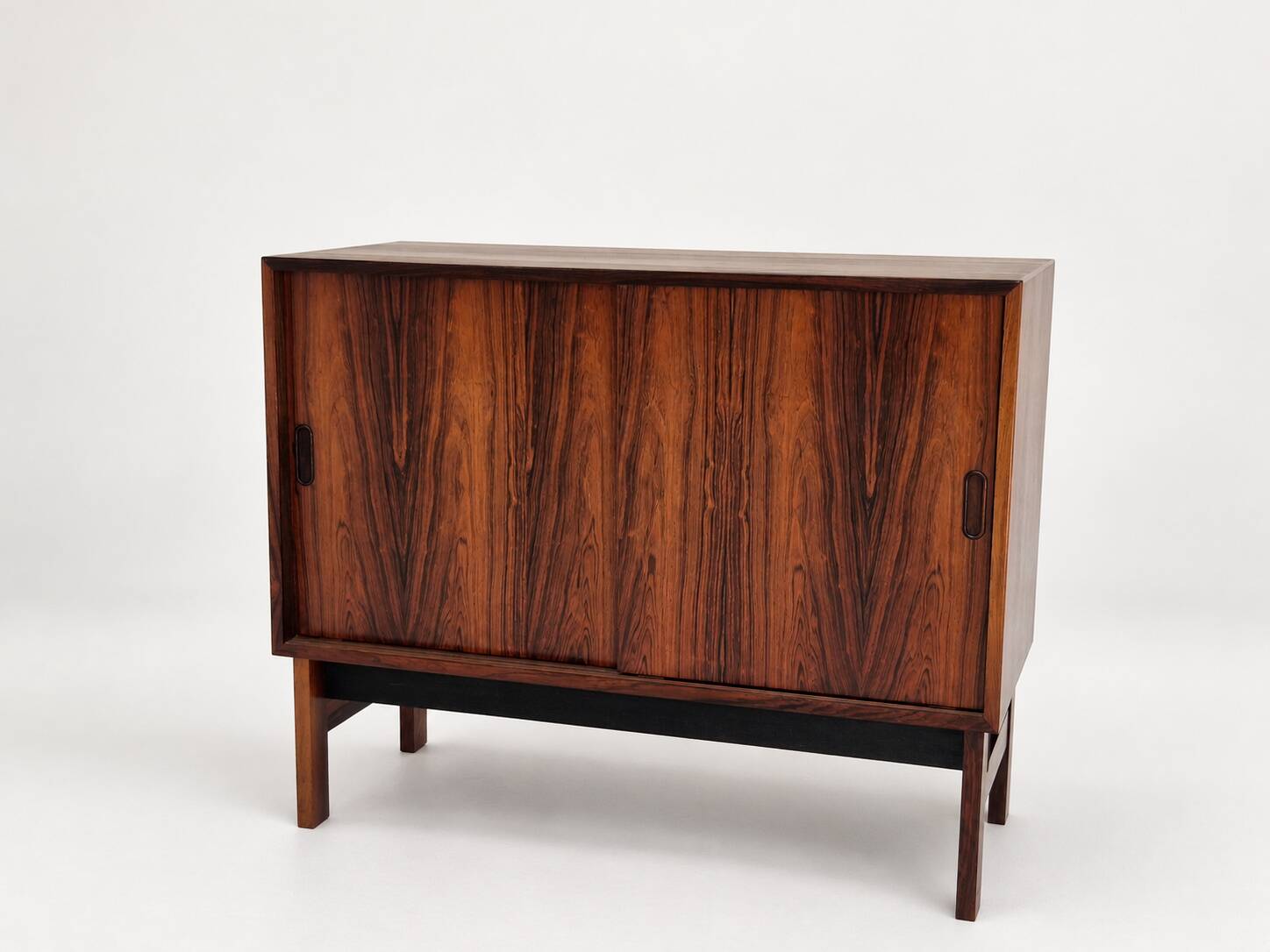 Low sideboard in rosewood with sliding doors. Denmark, 1960s
