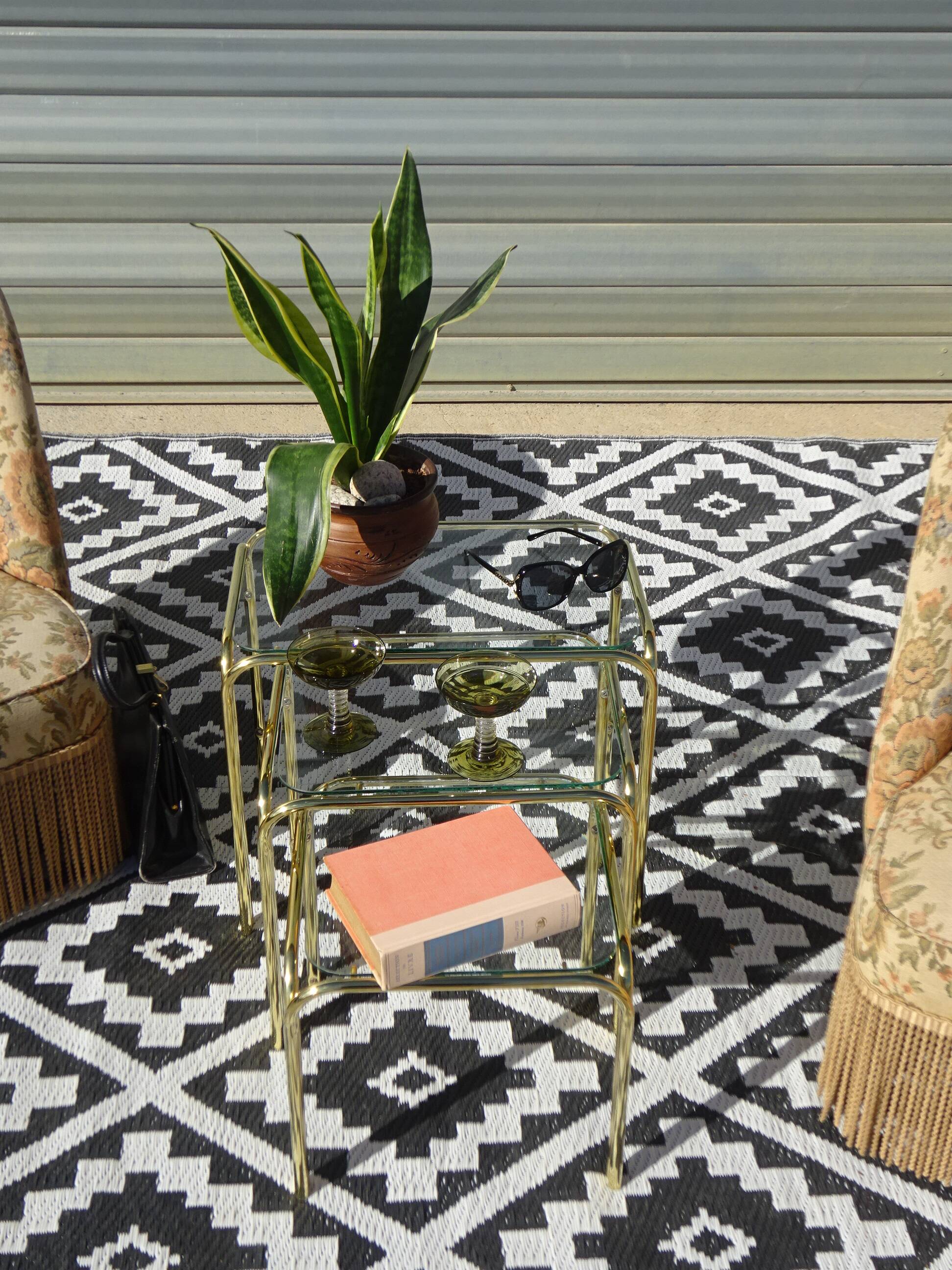 Nested tubular tables in gold metal.