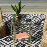 Nested tubular tables in gold metal.