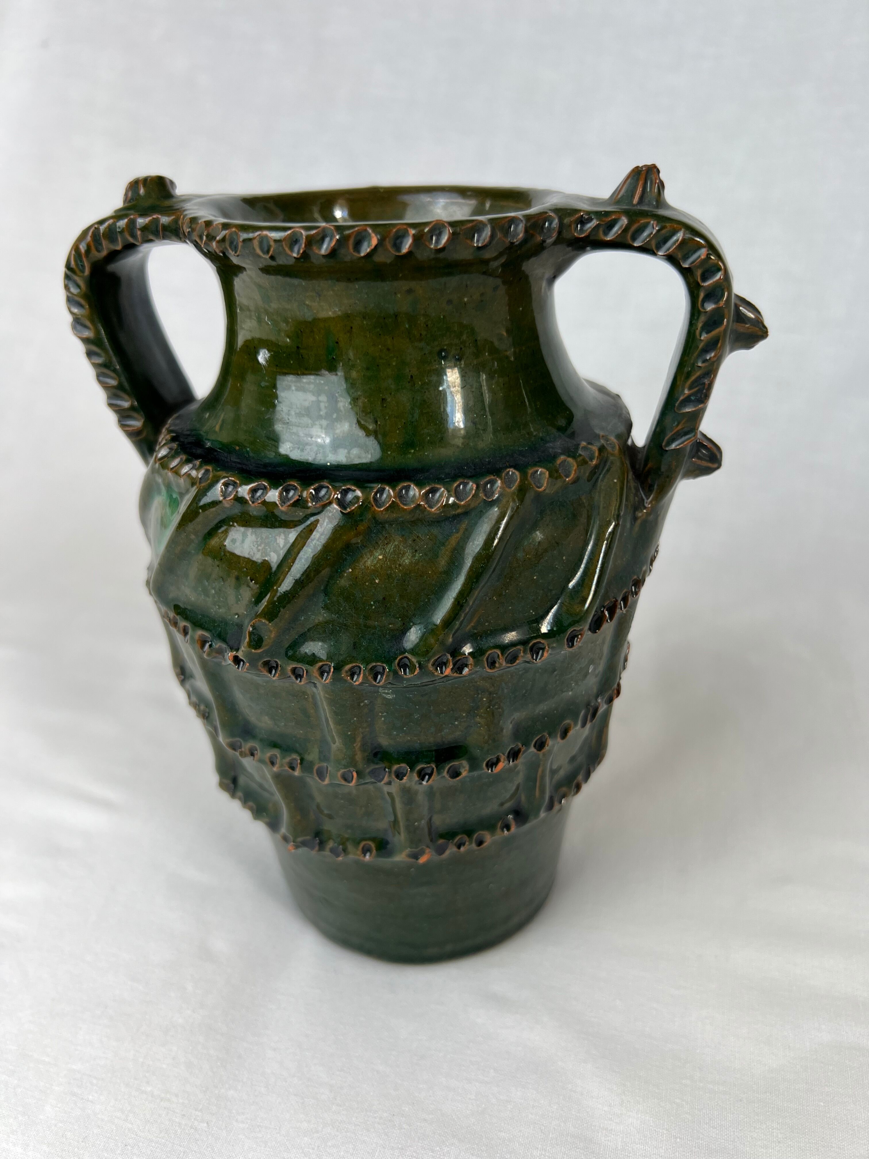Terracotta jar with dark green handles