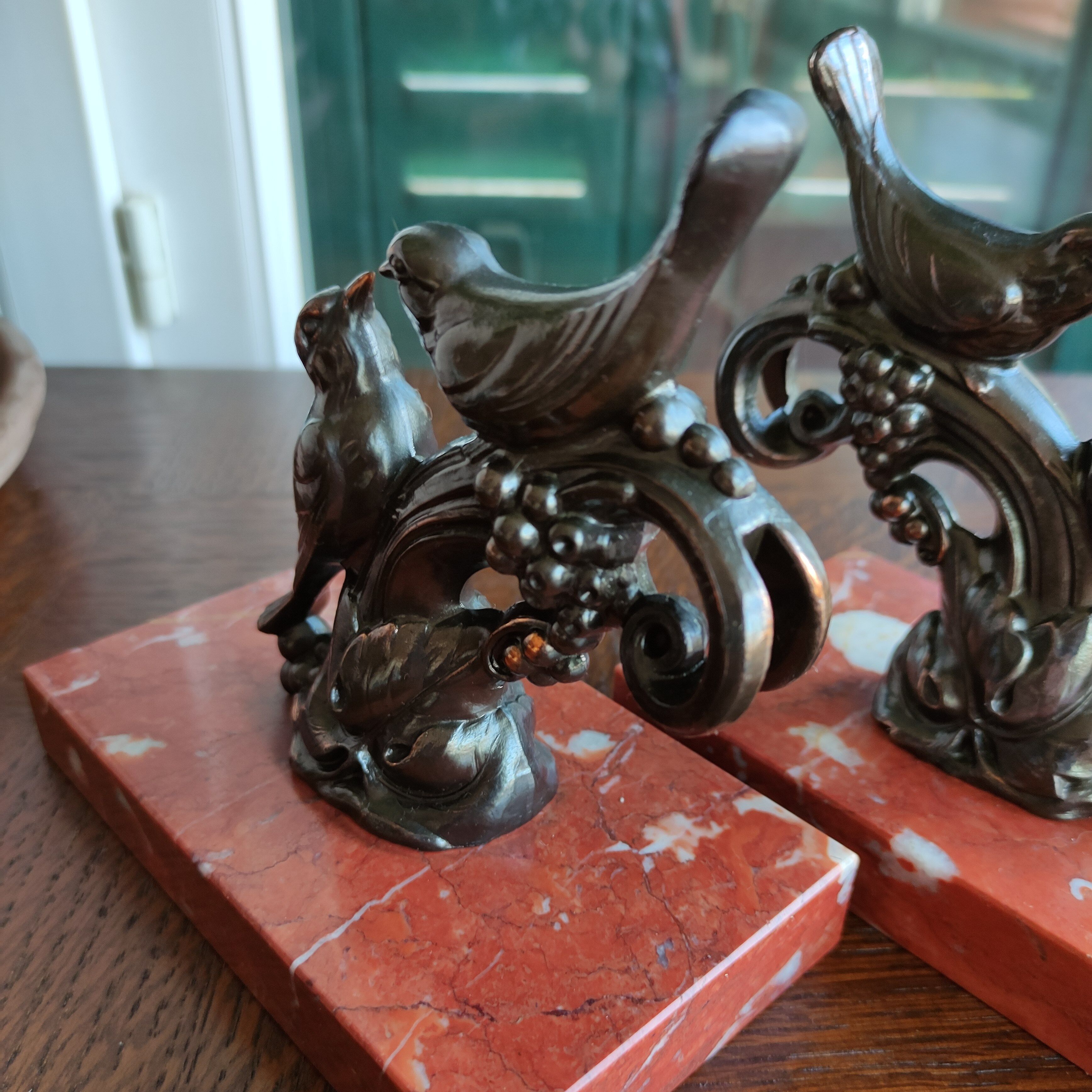 Zinc art bookends in the shape of birds on red marble - warblers