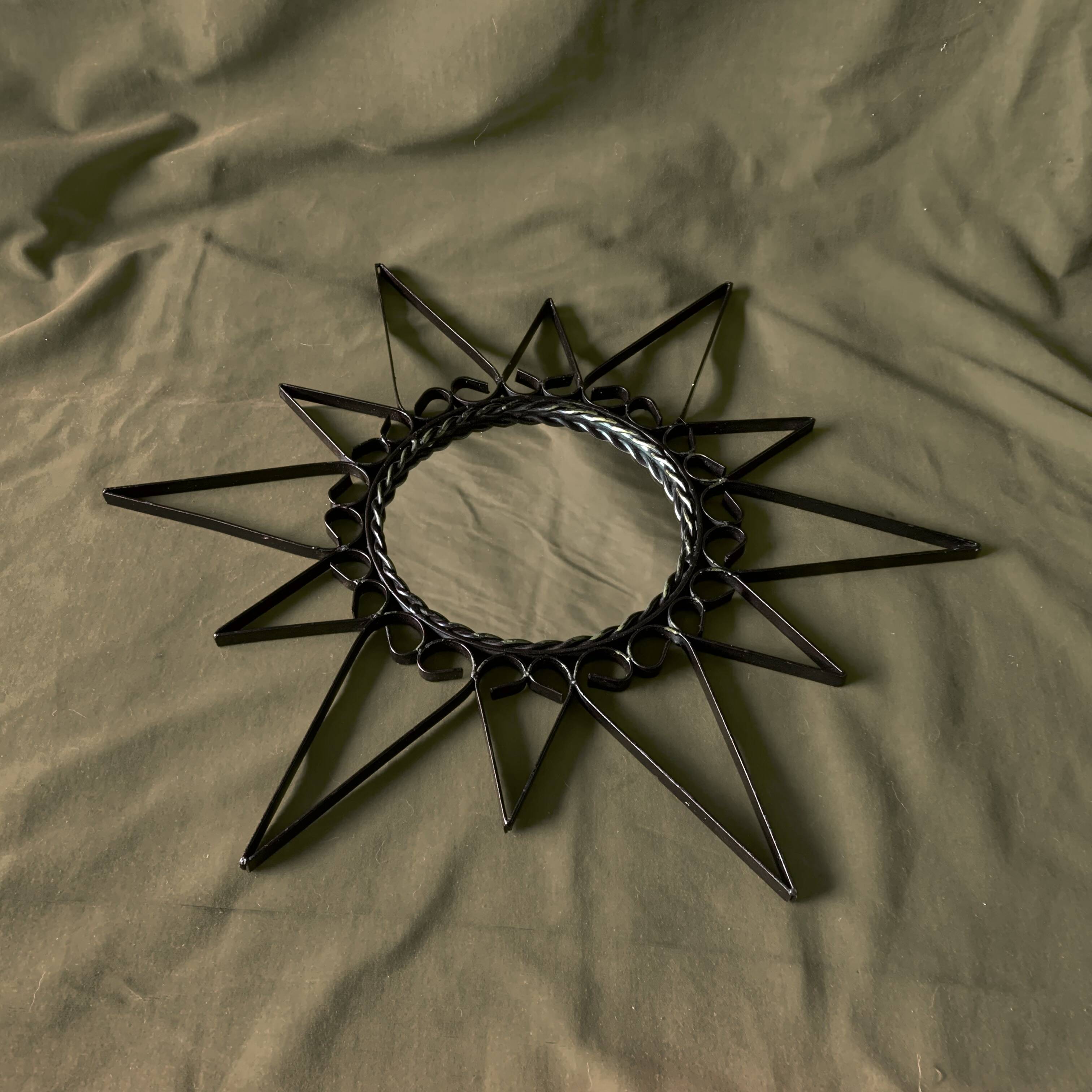 Old wrought metal sun mirror