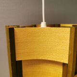 Older lamp in wood veneer, partially painted in green colour.