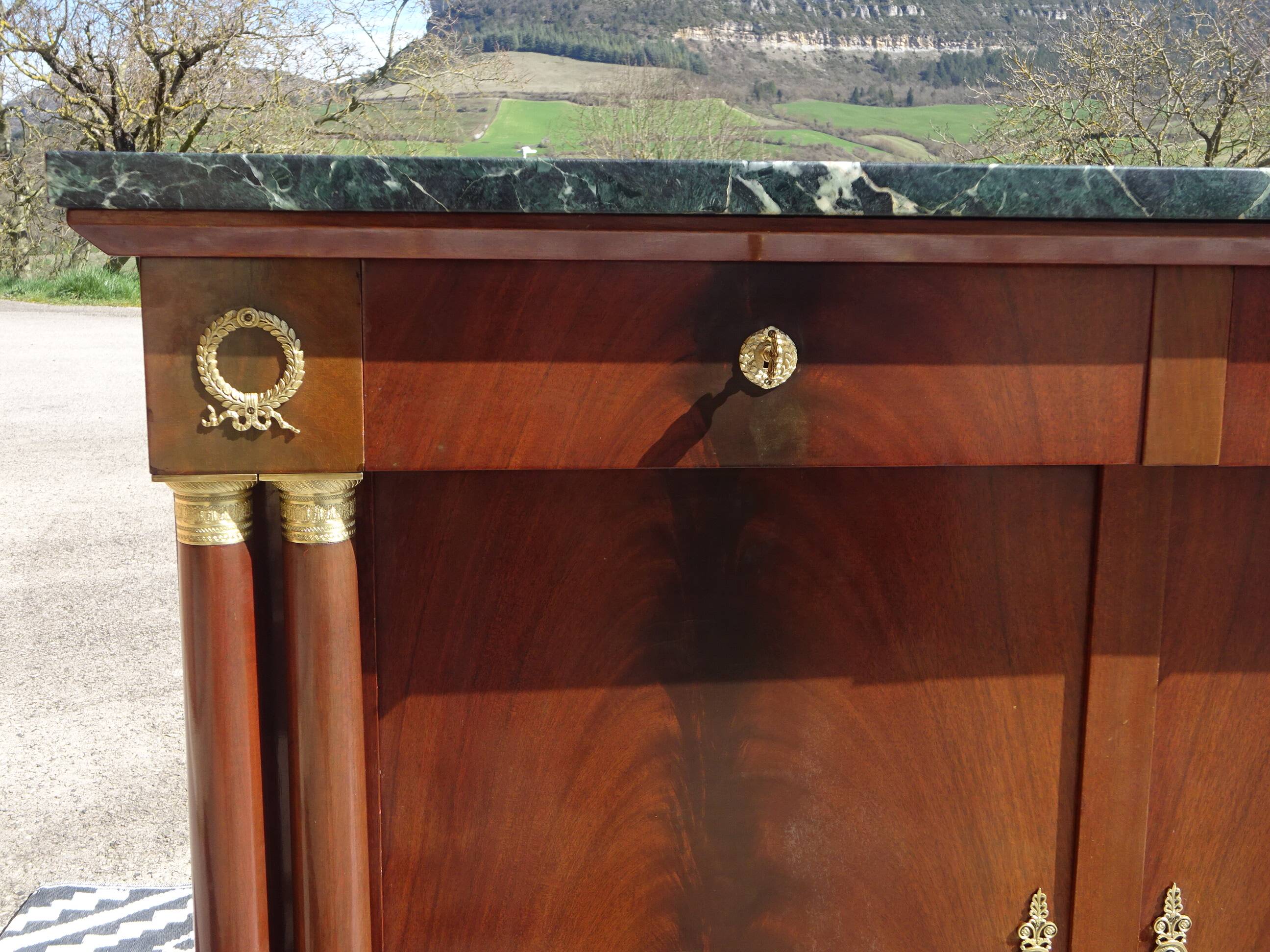 Flamed mahogany enfilade with sea green marble in Empire style.