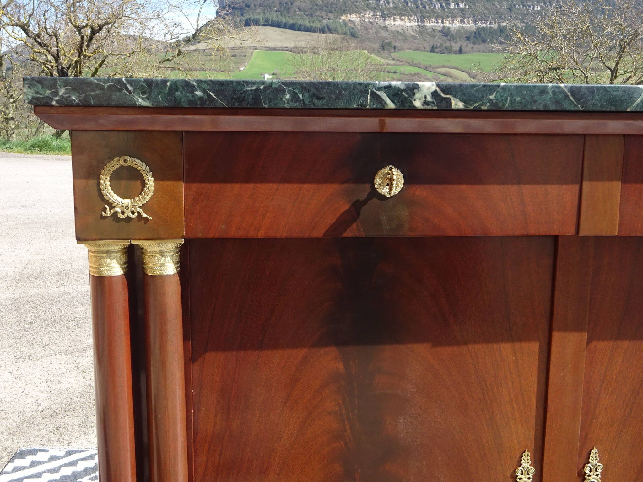 Flamed mahogany enfilade with sea green marble in Empire style.