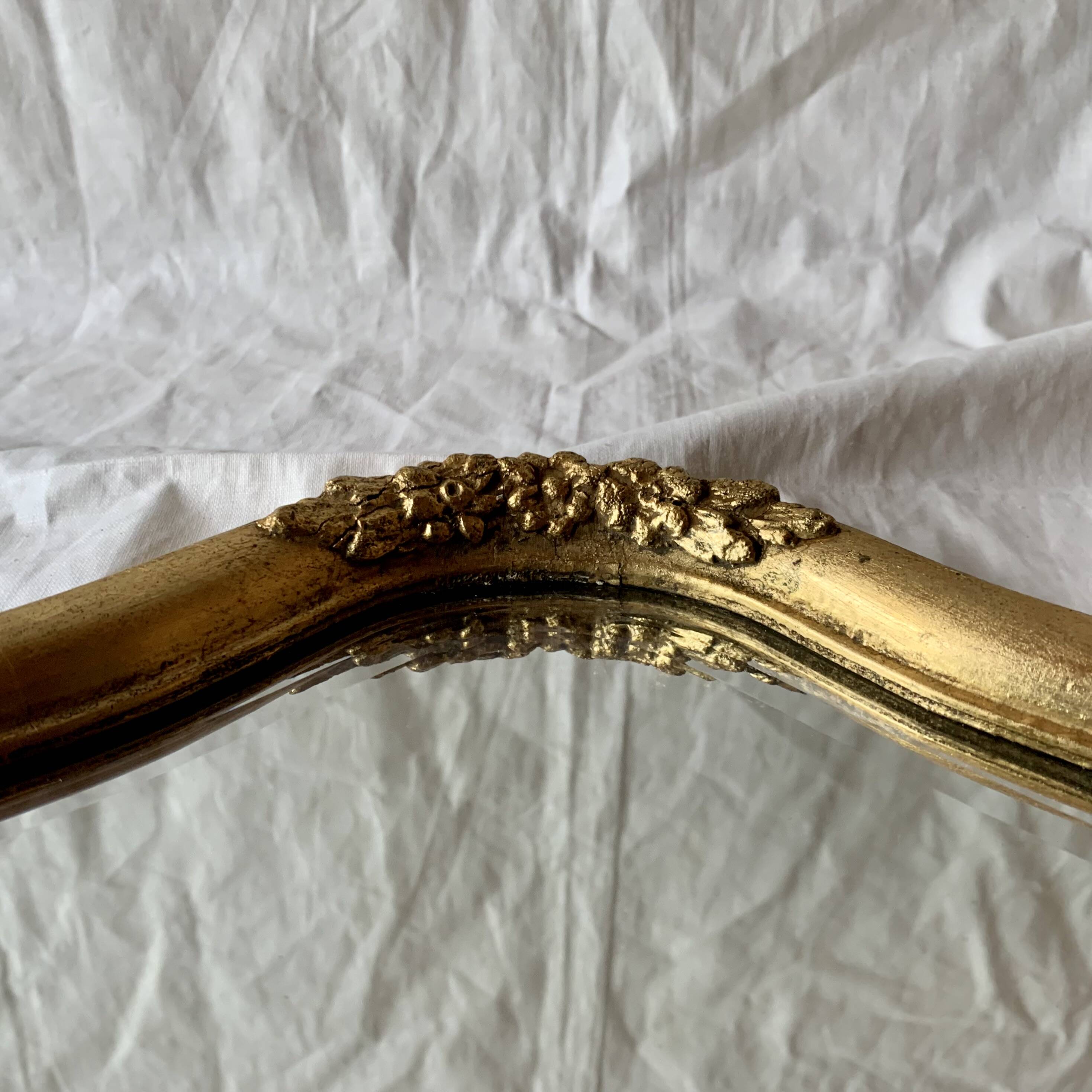 Antique beveled wall mirror in gilded solid wood