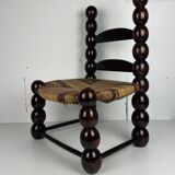 Brutalist wood turned bobbin low rush chair n the style of Charles Dudouyt