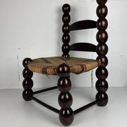 Brutalist wood turned bobbin low rush chair n the style of Charles Dudouyt