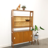 Vintage wooden showcase with sliding doors and white handles