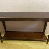 Mahogany console with a golden border.
