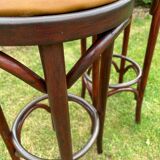 Pair of curved wooden bistro stools with leather seats