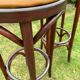 Pair of curved wooden bistro stools with leather seats