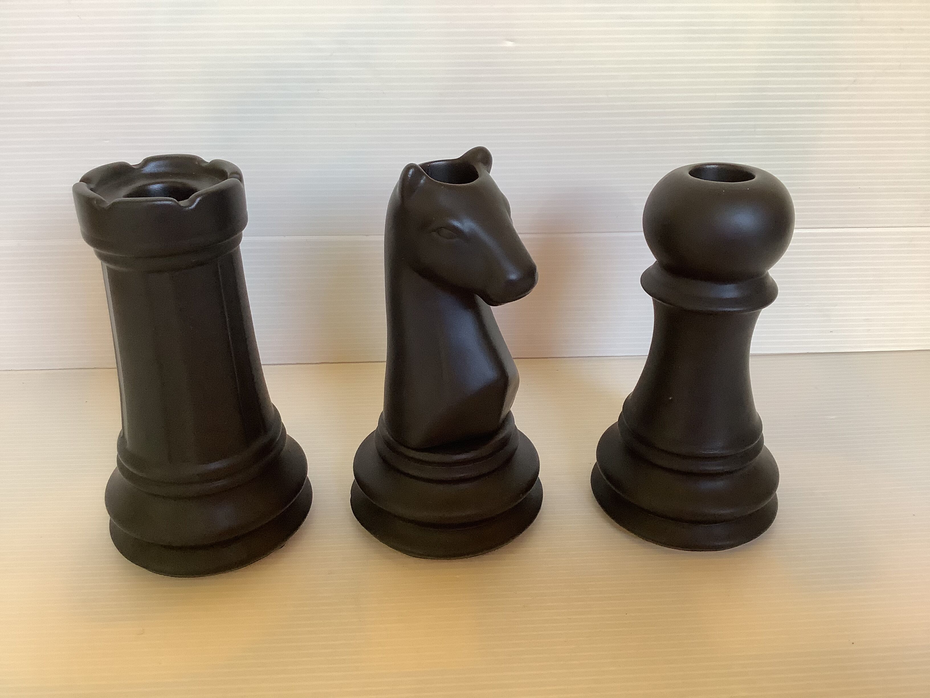 Trio of chess game candlesticks, rook, knight, pawn