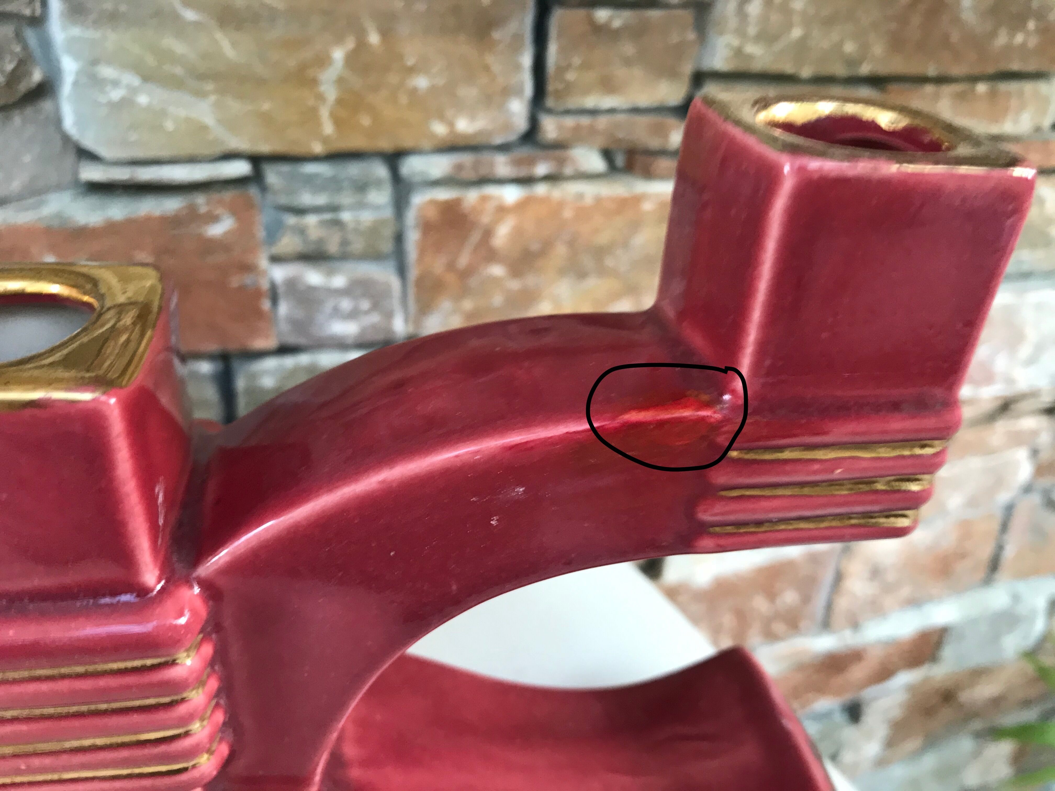 Former pair of burgundy ceramic candlesticks