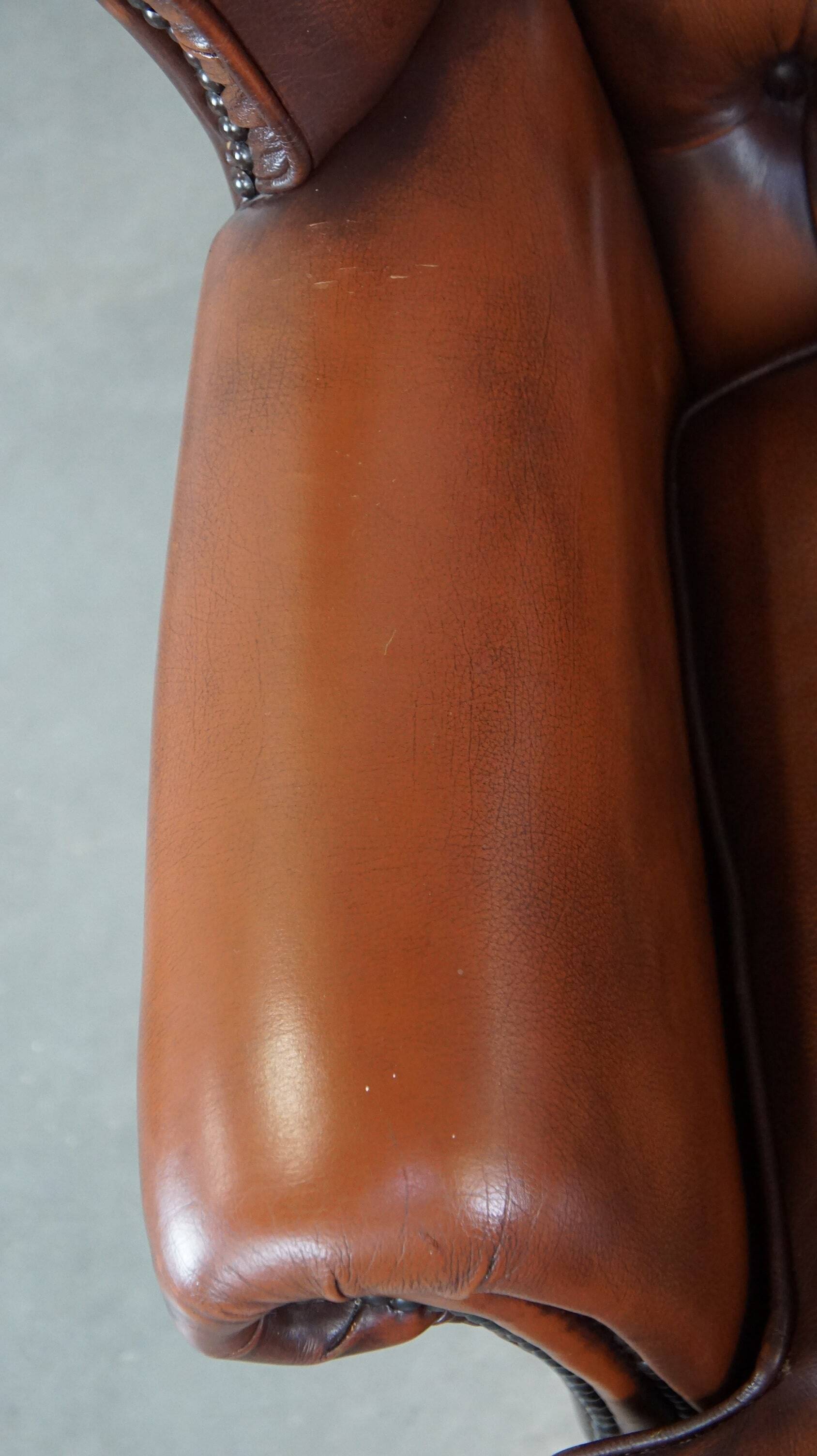 Brown leather wingback Chesterfield armchair