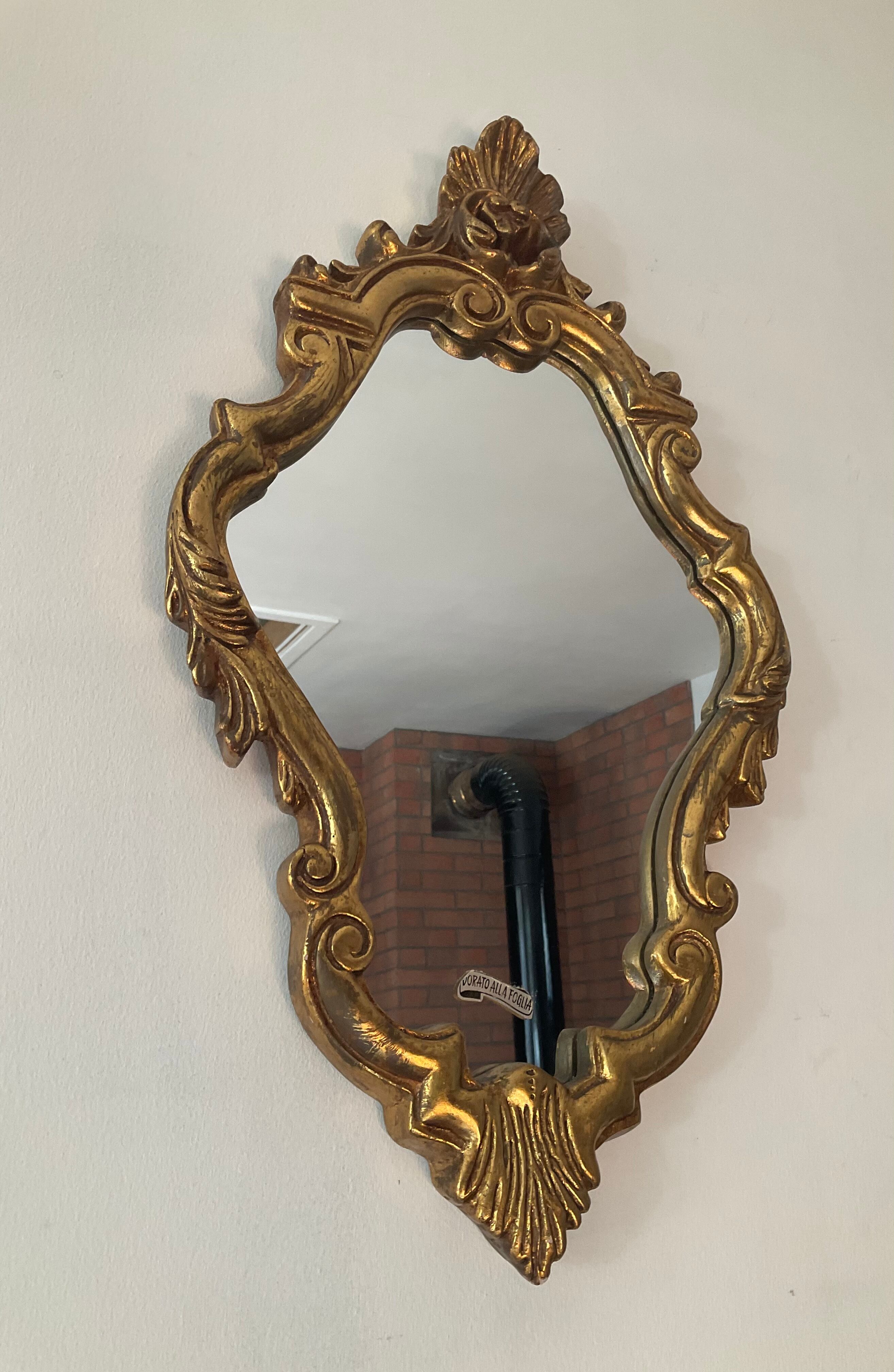 Old italian mirror in gilded plaster with leaf