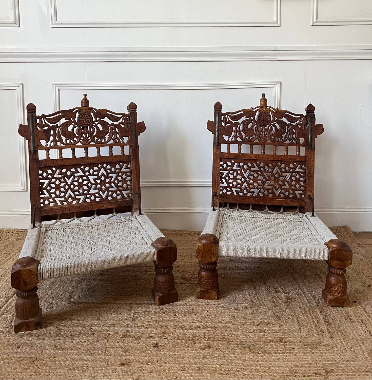 Pair of traditional Indian chairs made of carved wood and rope