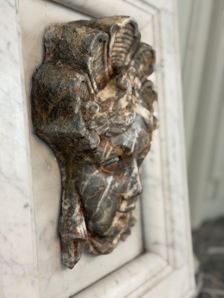 Female mascaron in grey Ardennes marble from the Regency period, 18th century.