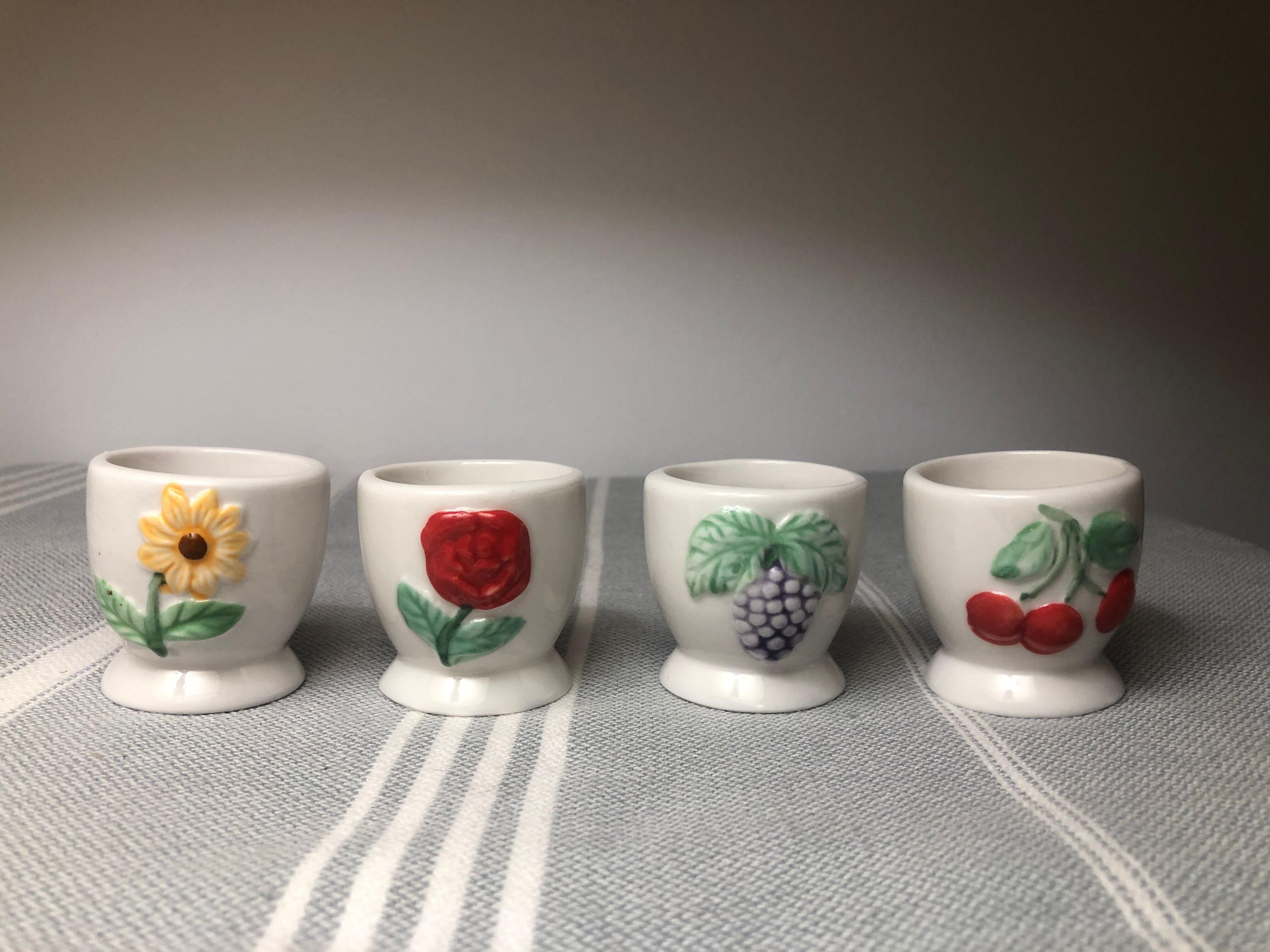 Ceramic shells with relief decoration of flowers (yellow and red) and fruits (cherries and grapes)