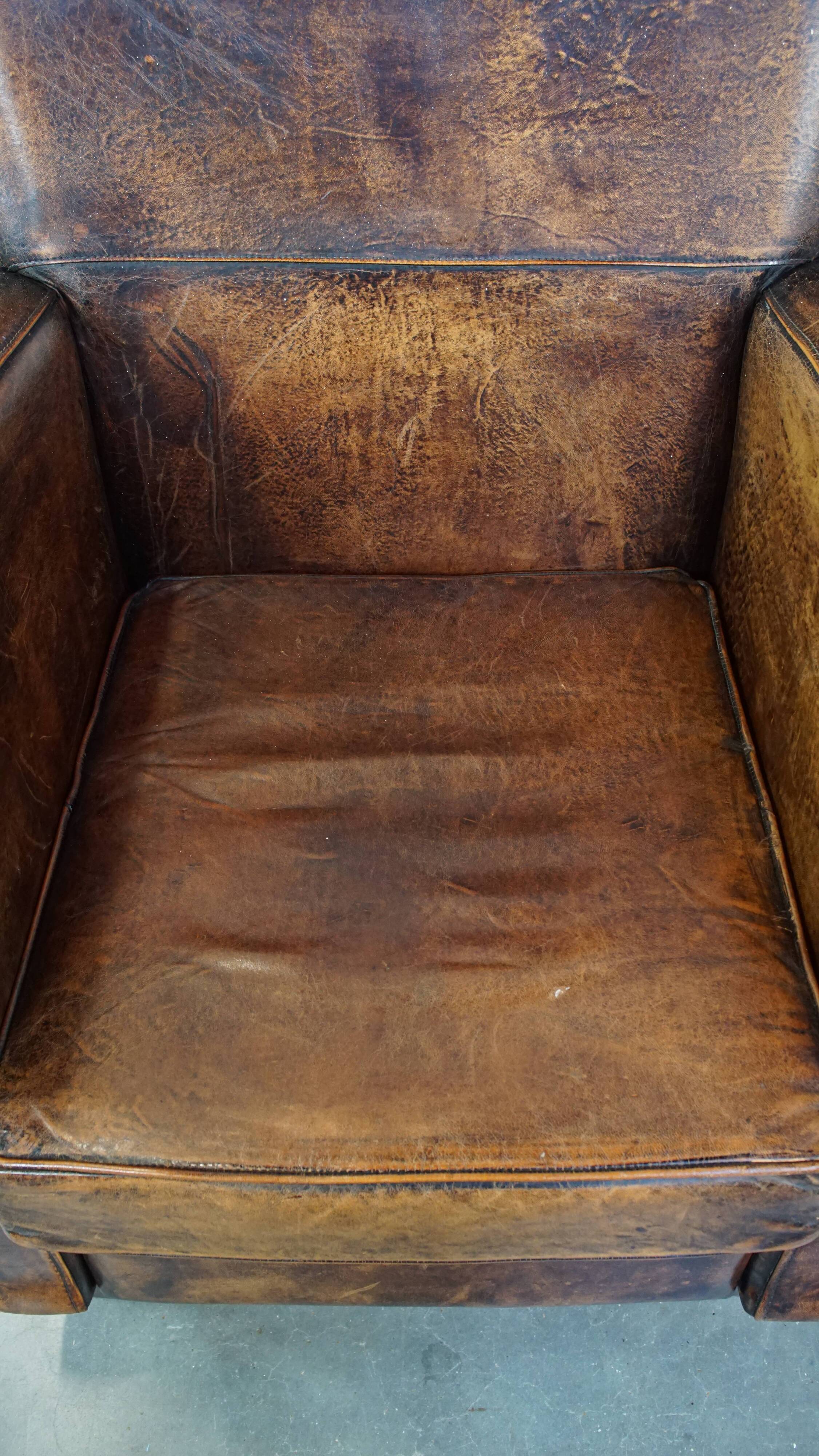 Dark brown design armchair made of sheepskin leather