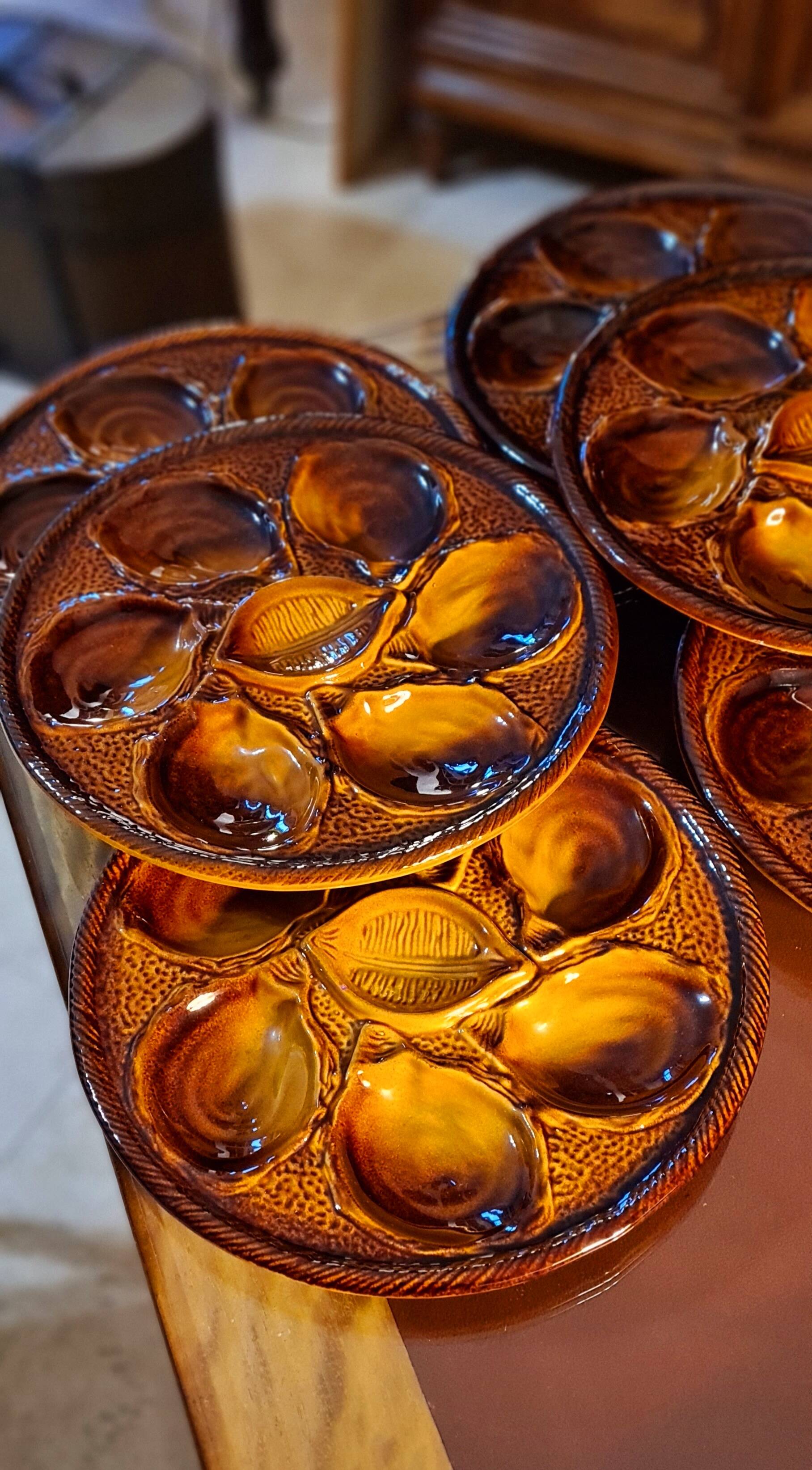 Six oyster plates signed Saint Clément