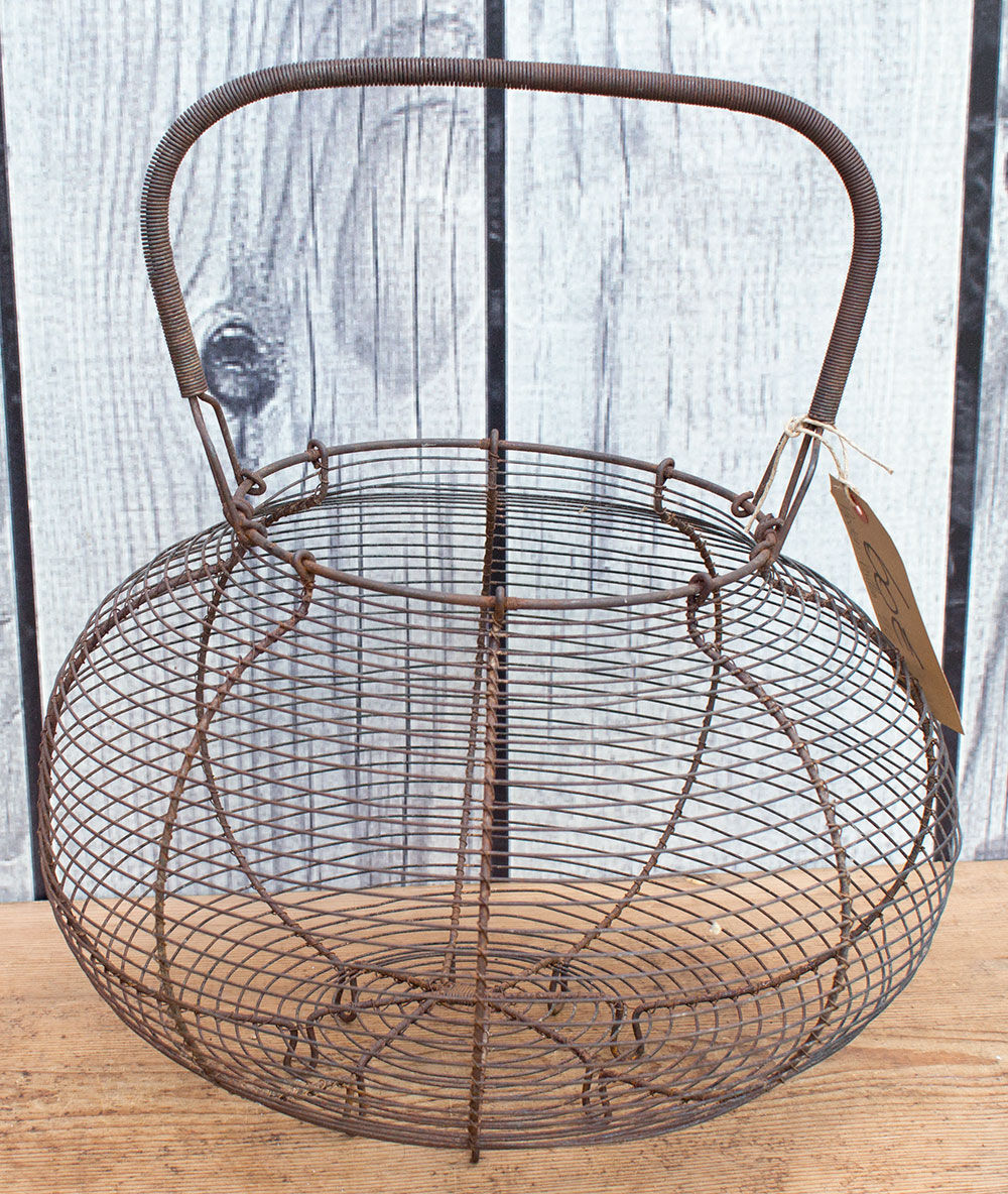 Old basket has wire eggs
