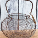 Old basket has wire eggs