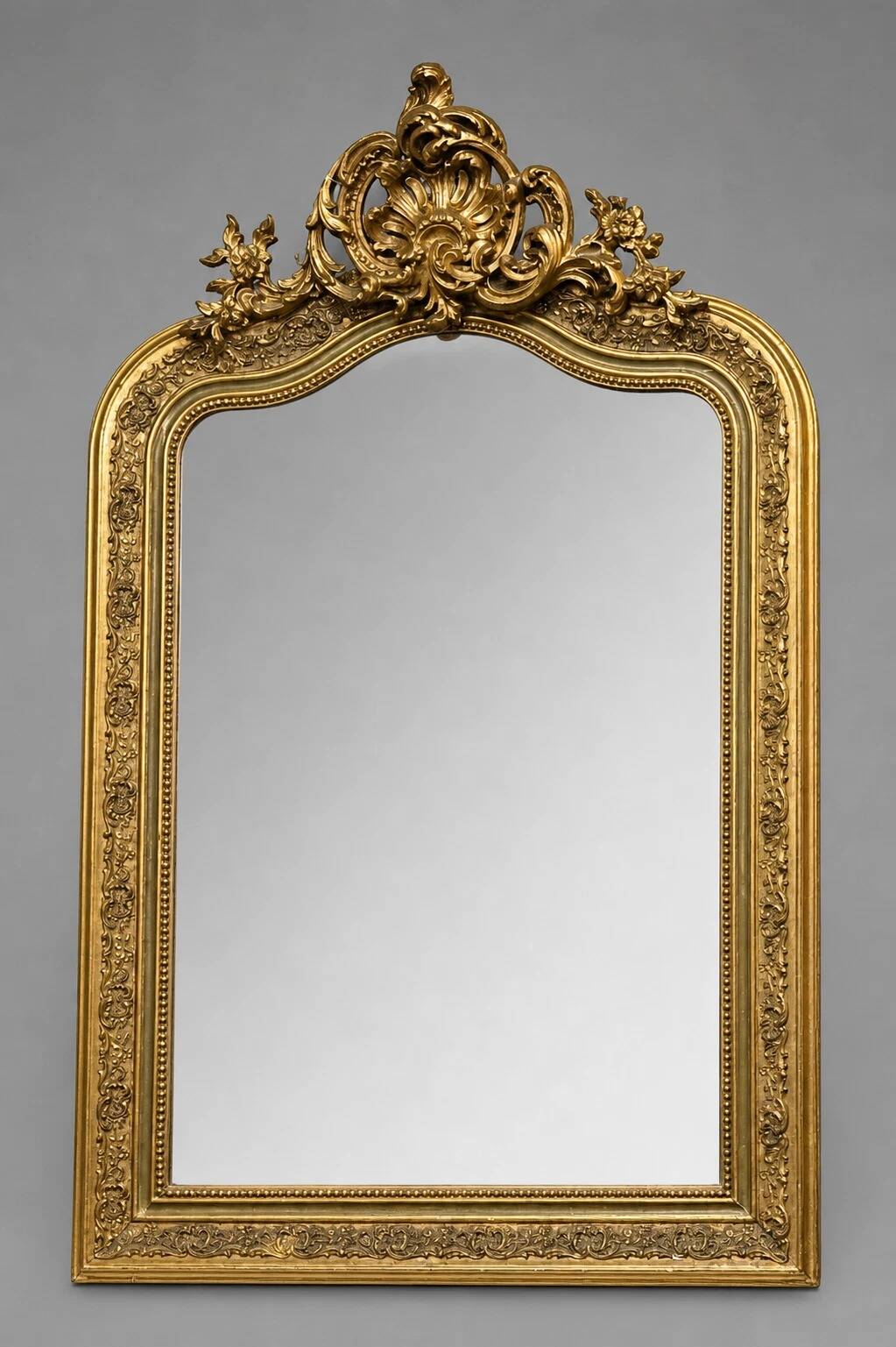Large carved and gilded wooden mirror, rectangular in shape.