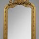 Large carved and gilded wooden mirror, rectangular in shape.
