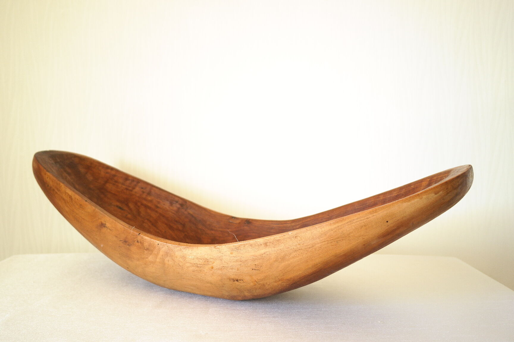 Brutalistic cut in exotic wood boomerang shape