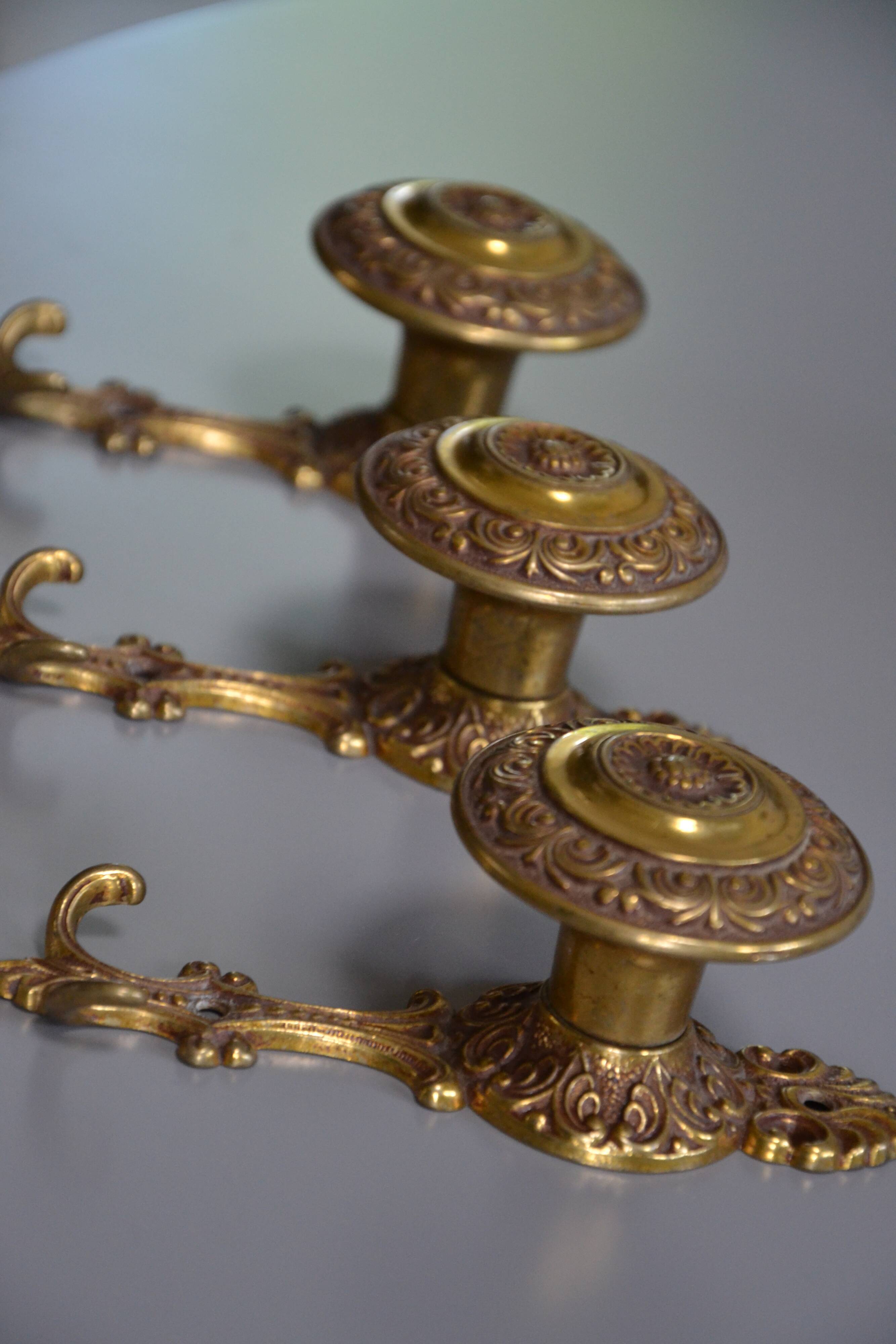 Three coat hooks with brass hook