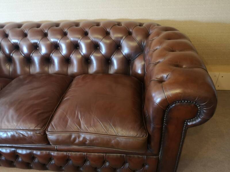 Vintage three-seater brown leather Chesterfield sofa