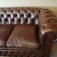 Vintage three-seater brown leather Chesterfield sofa