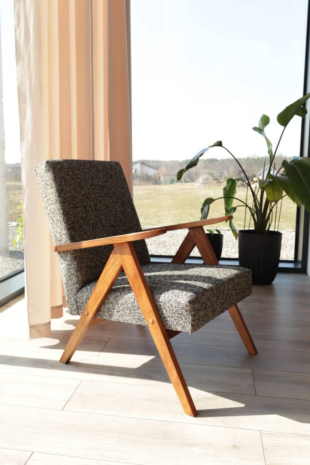 Vintage design armchair in mixed black fabric, walnut-coloured wood.