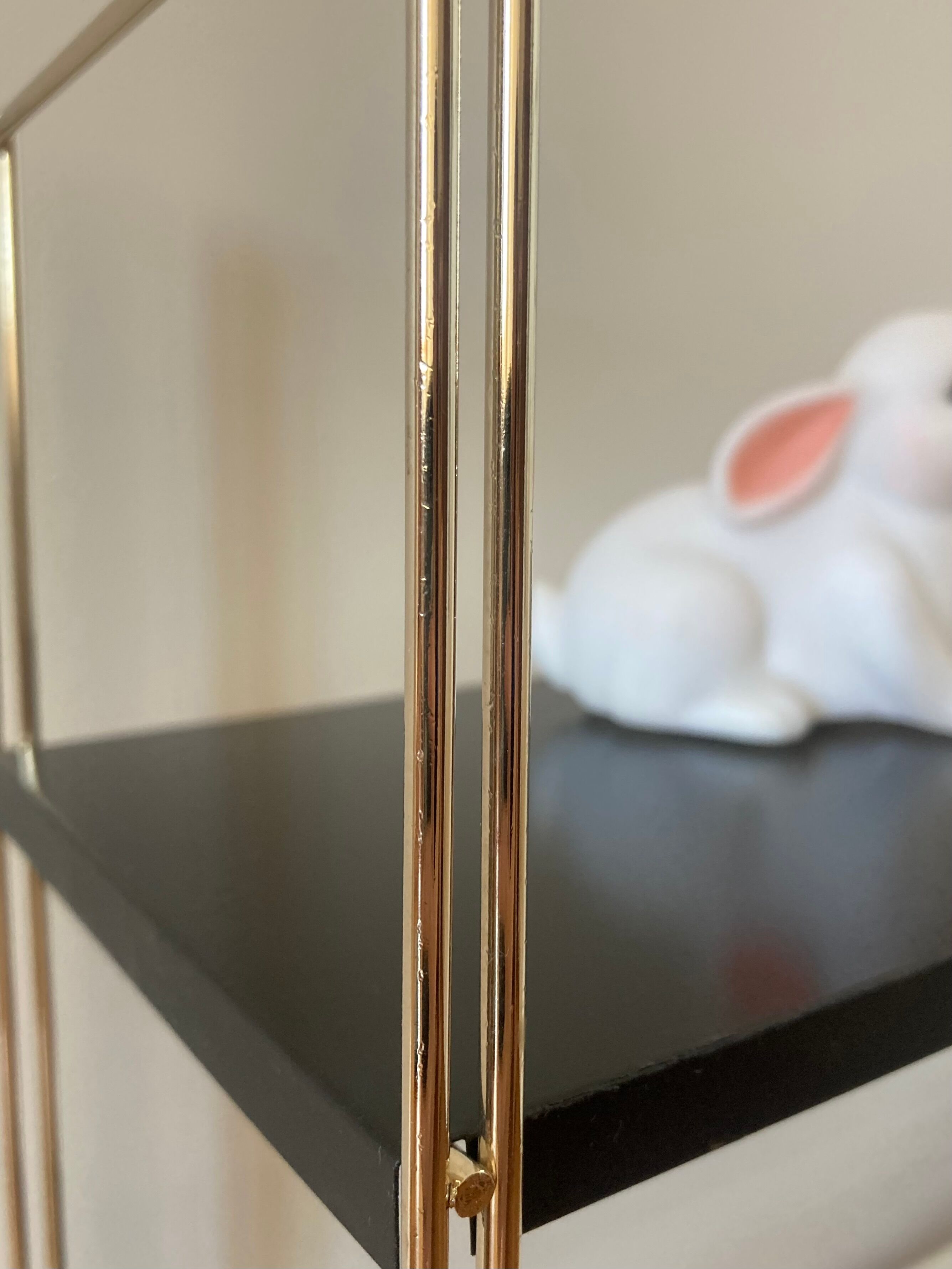 Black and gold string shelf