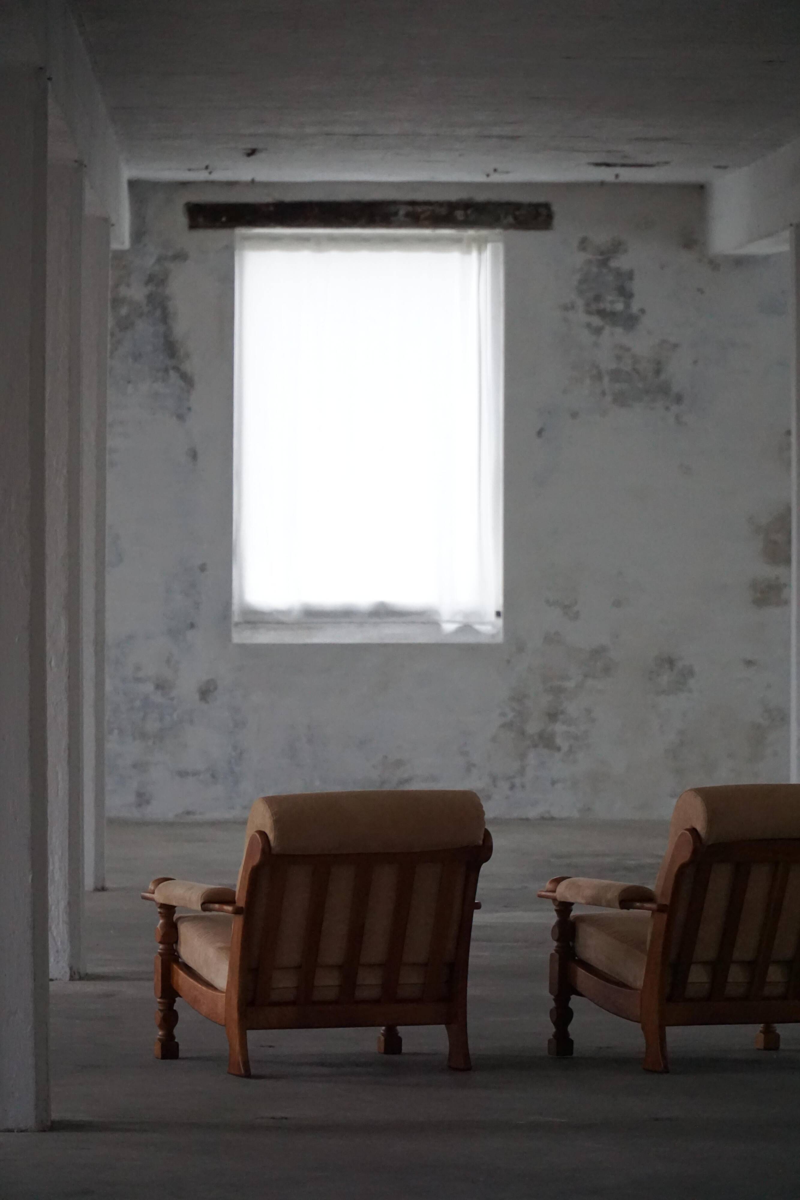 Mid-20th century, pair of armchairs by Henning Kjærnulf, oak and alcantara, 1960s.