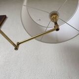 Floor lamp with articulated arm in brass-plated metal