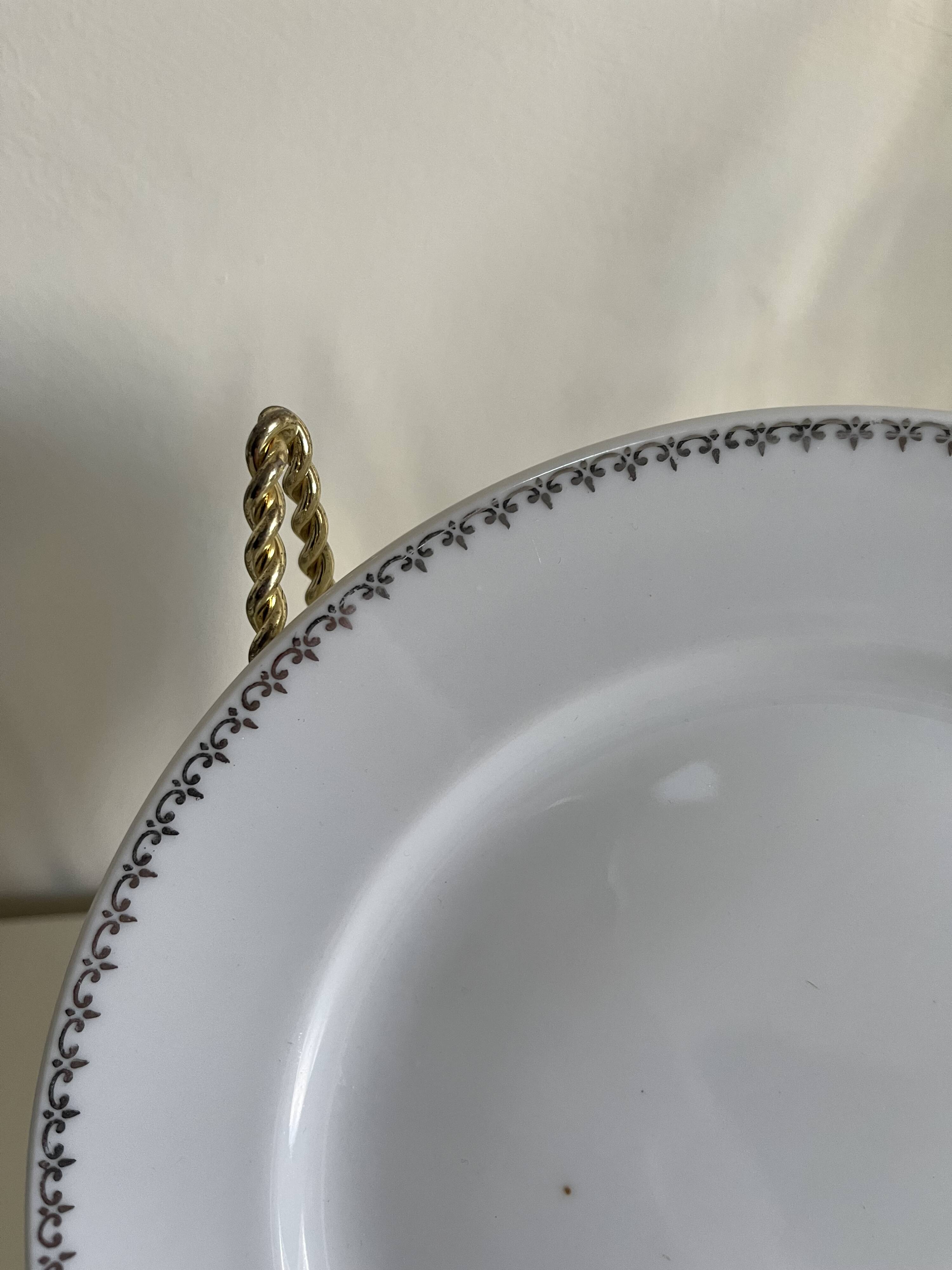 12 white porcelain plates with silver edging