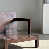 Small low armchair in varnished brown wood