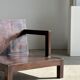 Small low armchair in varnished brown wood