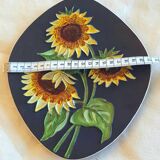 Decorative wall plate with sunflowers.