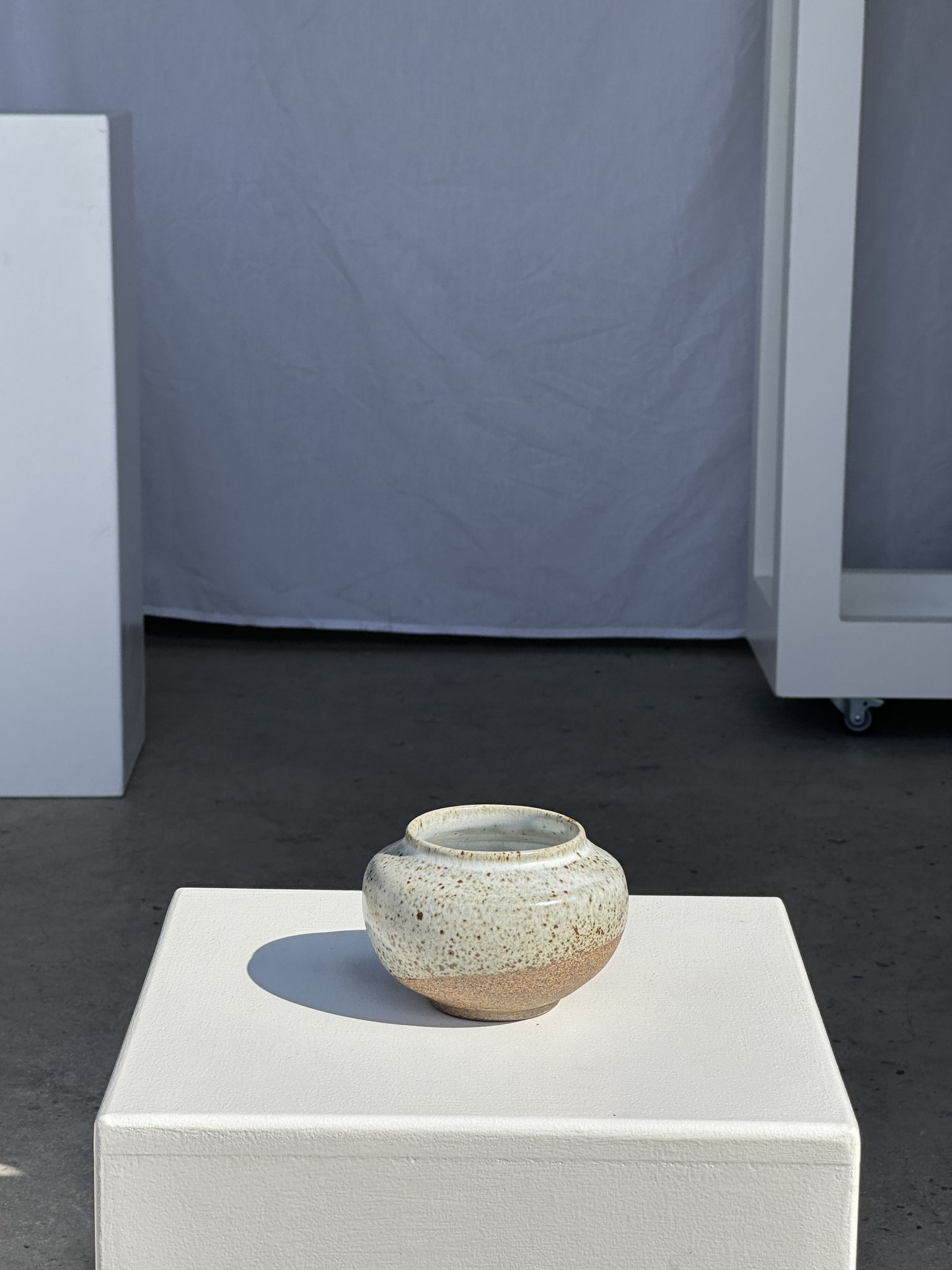 Small white ball vase tight neck in glazed speckled ceramic